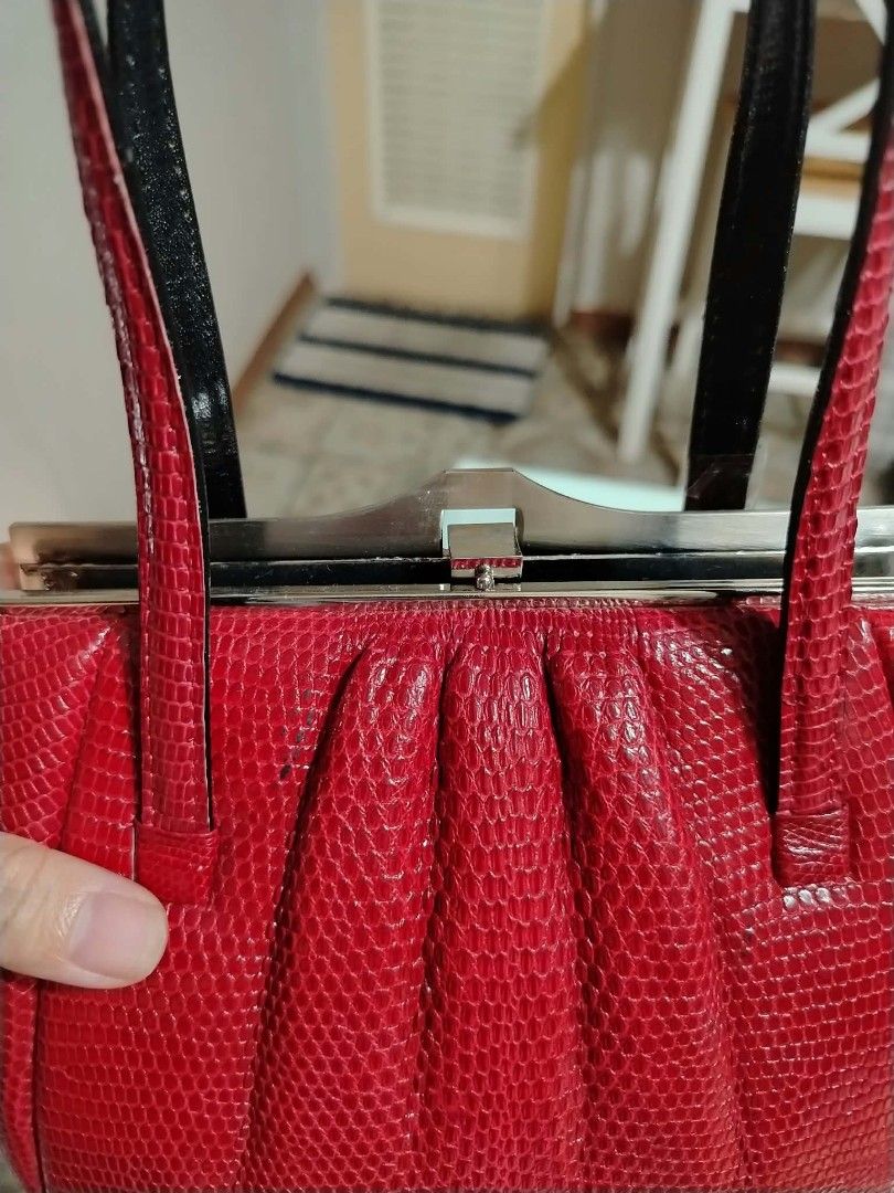 Genuine lizard kiss lock handbag (Category: Shoulder Bags) located in Paranaque City. Submitted by yensfashionfinds (Listing ID 1468739766, Image 3). Description: - Color & Texture: Bright red genuine lizard - Design: Structured body with trendy gathered front pleats - Closure: Secure silver-tone kiss lock frame - Straps: Dual handles in a contrasting dark tone - Base: Flat rectangular base for stability - Size: Compact yet spacious enough for da
