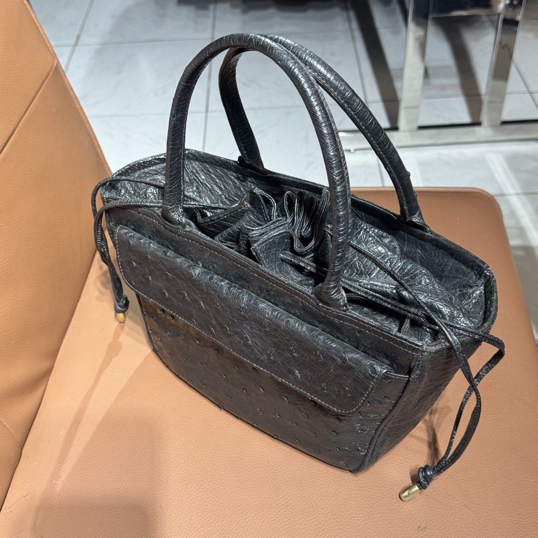 Genuine ostrich leather handbag (Category: Tote Bags) located in Rizal. Submitted by houseofbell (Listing ID 1468925205, Image 3). Description: - Material ostrich leather - Design: Structured tote bag with clean stitching throughout - Handles: Twin top handles for easy everyday carrying - Pockets & Closure: Front flap pocket with snap closure and open main compartment - Special Details: Drawstring sides with metallic tips and reinforced flat bott