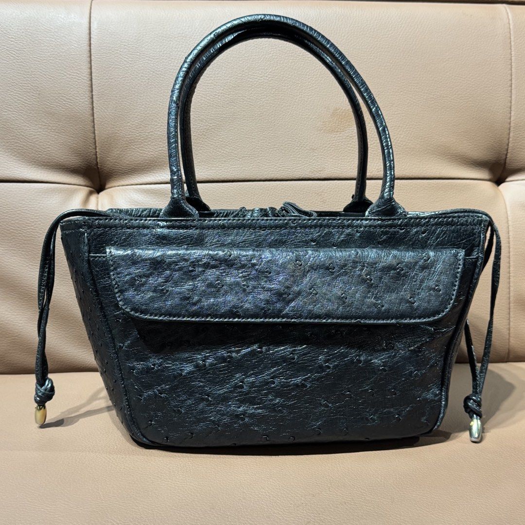 Genuine ostrich leather handbag (Category: Tote Bags) located in Rizal. Submitted by houseofbell (Listing ID 1468925205, Image 1). Description: - Material ostrich leather - Design: Structured tote bag with clean stitching throughout - Handles: Twin top handles for easy everyday carrying - Pockets & Closure: Front flap pocket with snap closure and open main compartment - Special Details: Drawstring sides with metallic tips and reinforced flat bott