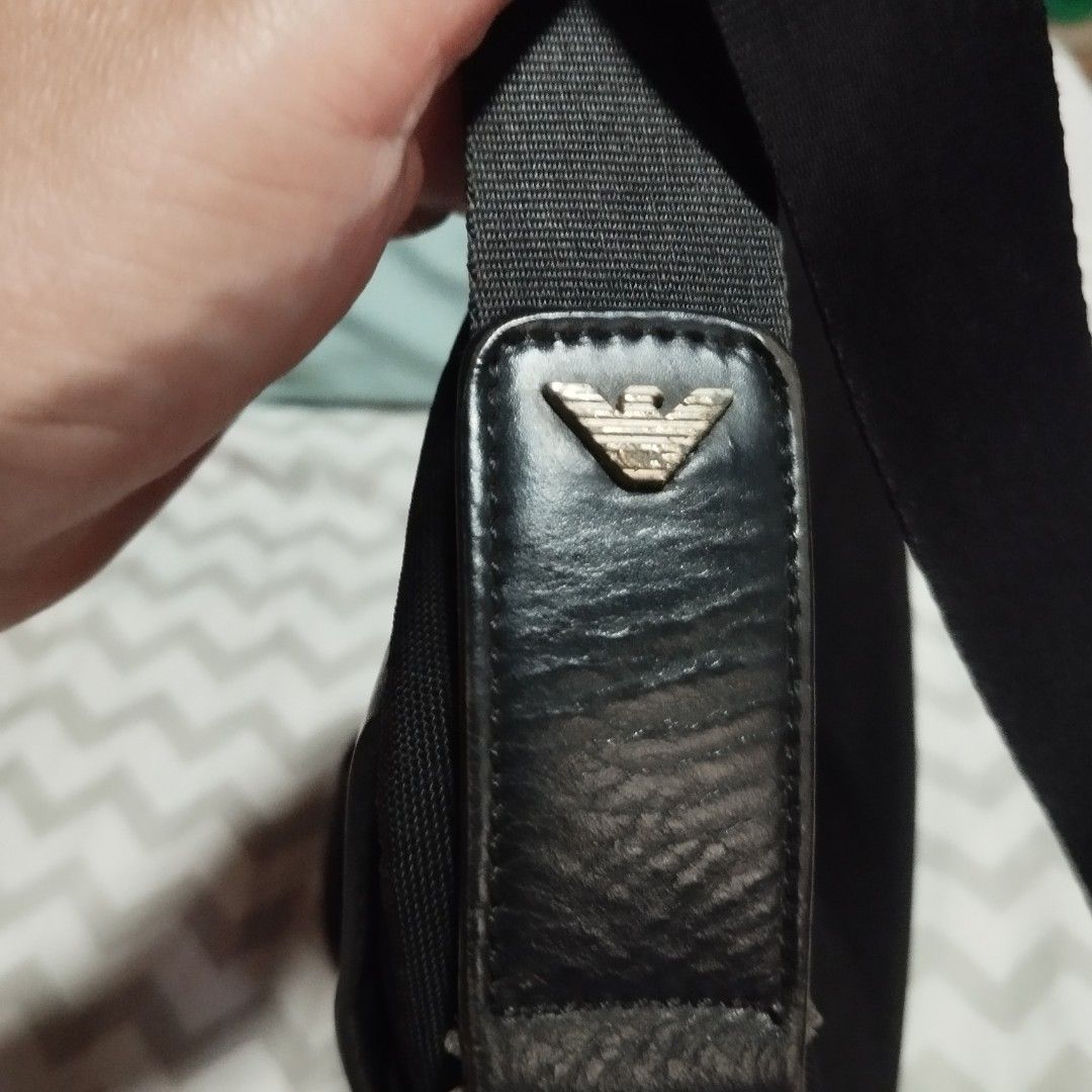 Giorgio Armani Black Leather Messenger Bag (Category: Sling Bags) located in Manila. Submitted by lene48 (Listing ID 1468747441, Image 3). Description: - AGiorgio Armani black messenger bag - Sleek design with embossed branding and signature eagle logo strap - Durable fabric body built for daily wear - Adjustable shoulder strap for a comfortable fit - Spacious main compartment fits work documents and essentials - Interior zippered pocket for secu