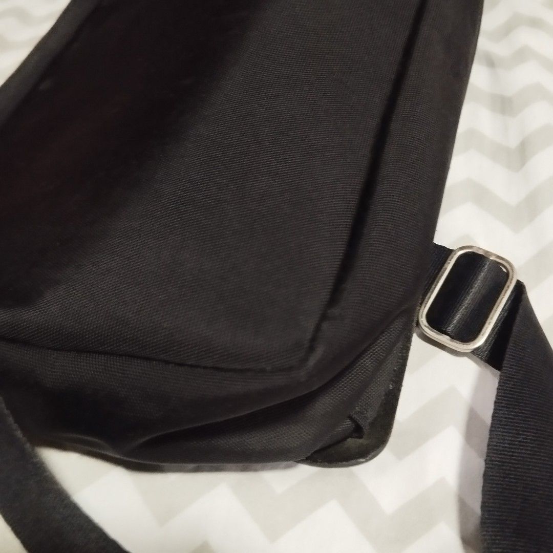 Giorgio Armani Black Messenger Bag (Category: Sling Bags) located in Manila. Submitted by lene48 (Listing ID 1468836289, Image 3). Description: - Brand: Giorgio Armani - Material: Premium smooth leather and durable fabric - Closure: Secure main zip closure with front flap - Interior: Includes zip pocket, internal organiser slots, and branded lining - Exterior: Adjustable strap with metallic hardware, branding badge, and debossed logo strap - Cond