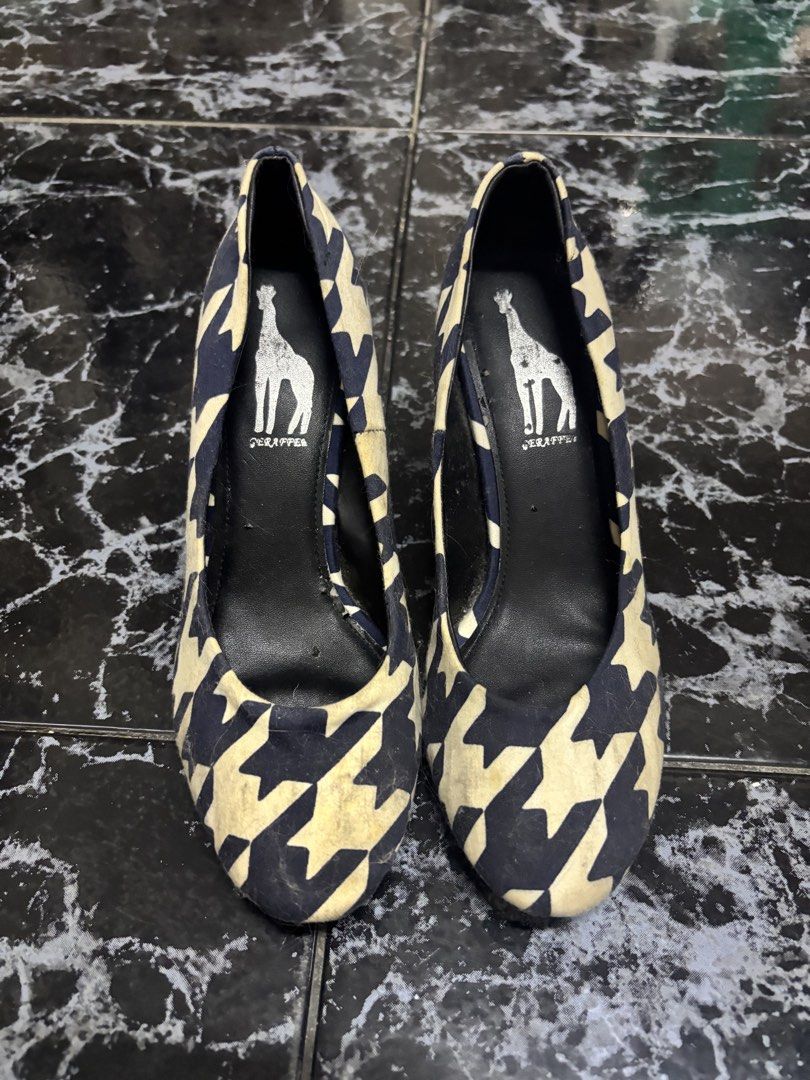 Giraffe Navy Blue White Houndstooth Heels Size 39 (Category: Heels) located in Manila. Submitted by urthrifthany (Listing ID 1468724801, Image 1). Description: - Brand: Giraffe - Style: Pointed toe medium stiletto heels - Pattern/Color: Navy blue and white houndstooth - Size: 39 (stamped on sole) - Details: Black inner lining and branded graphic inside - Condition: Minor wear visible on fabric near the toe area.