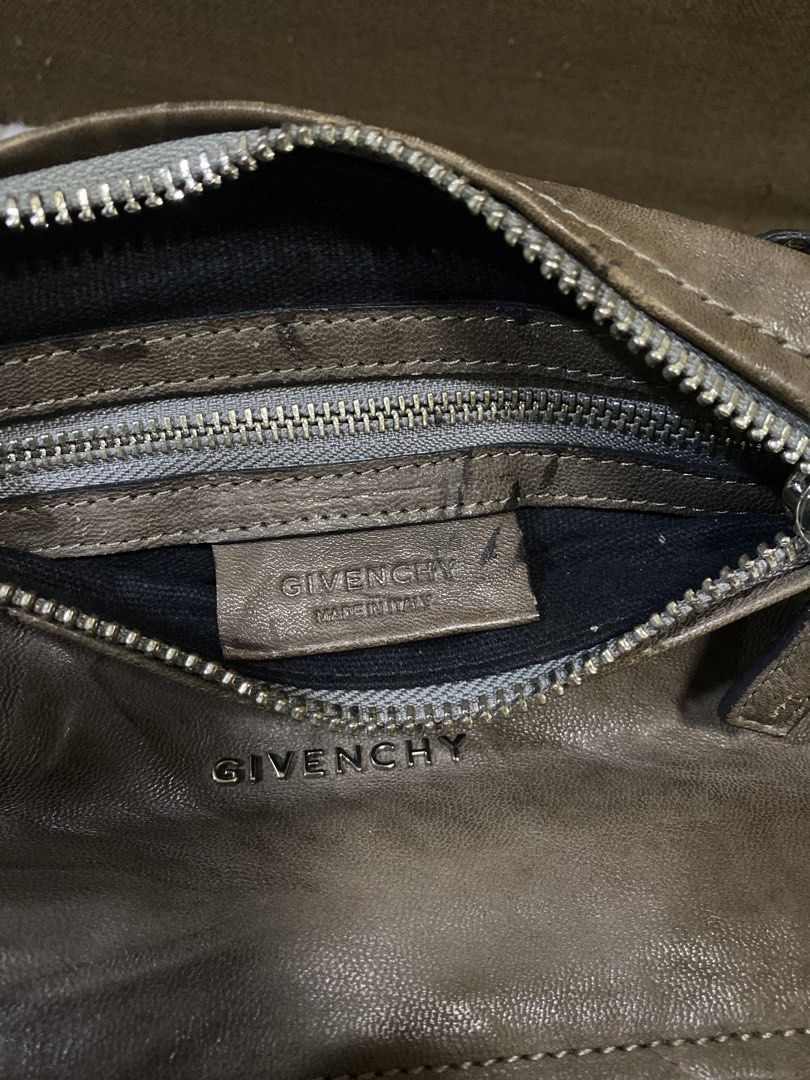 Givenchy Pandora Leather Crossbody Bag (Category: Cross-body Bags) located in San Antonio. Submitted by clinicallycute_. (Listing ID 1468872434, Image 3). Description: - Brand: Givenchy - Model: Pandora Crossbody Bag - Color: Greyish-brown - Material: Leather with silver-tone hardware - Details: Embossed Givenchy lettering on front, adjustable shoulder strap - Interior: Black fabric lining with a zip pocket and Made in Italy leather tag - Conditi