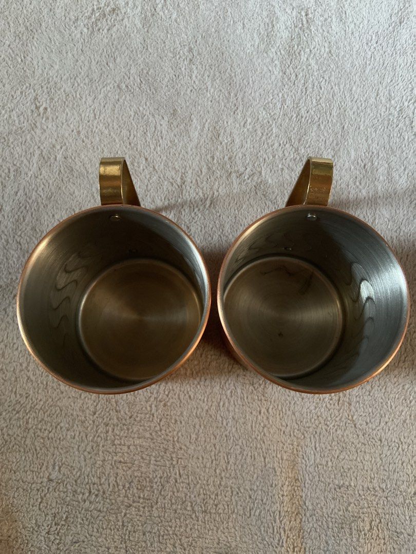 Glmitcopper Copper Mugs Set of Two (Category: Coffee & Tea Tableware) located in Davao. Submitted by mengsmixitems (Listing ID 1468713551, Image 2). Description: - Set of 2 authentic copper mugs - Features brass handles and a stylish wave-etched pattern - Silver-lined interior for safe and cool drinking - Stamped maker's mark on the bottom for authenticity - Ideal for serving Moscow Mules, cold beverages, or as a display piece.