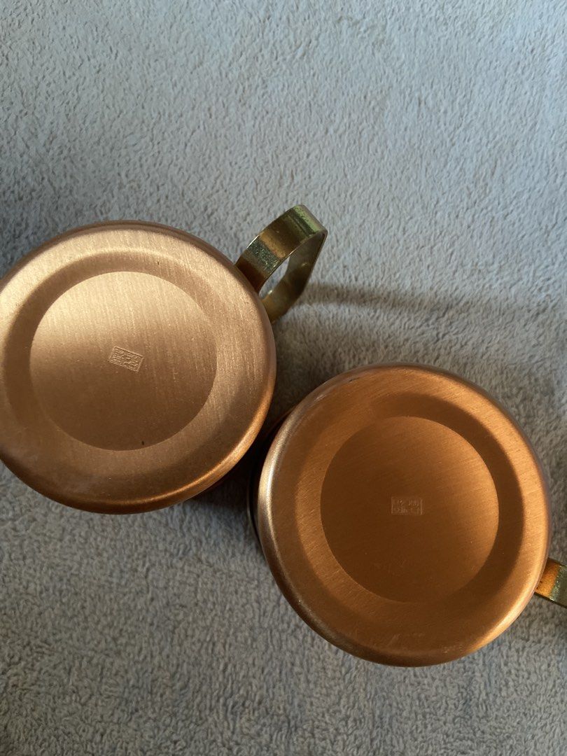 Glmitcopper Copper Mugs Set of Two (Category: Coffee & Tea Tableware) located in Davao. Submitted by mengsmixitems (Listing ID 1468713551, Image 3). Description: - Set of 2 authentic copper mugs - Features brass handles and a stylish wave-etched pattern - Silver-lined interior for safe and cool drinking - Stamped maker's mark on the bottom for authenticity - Ideal for serving Moscow Mules, cold beverages, or as a display piece.