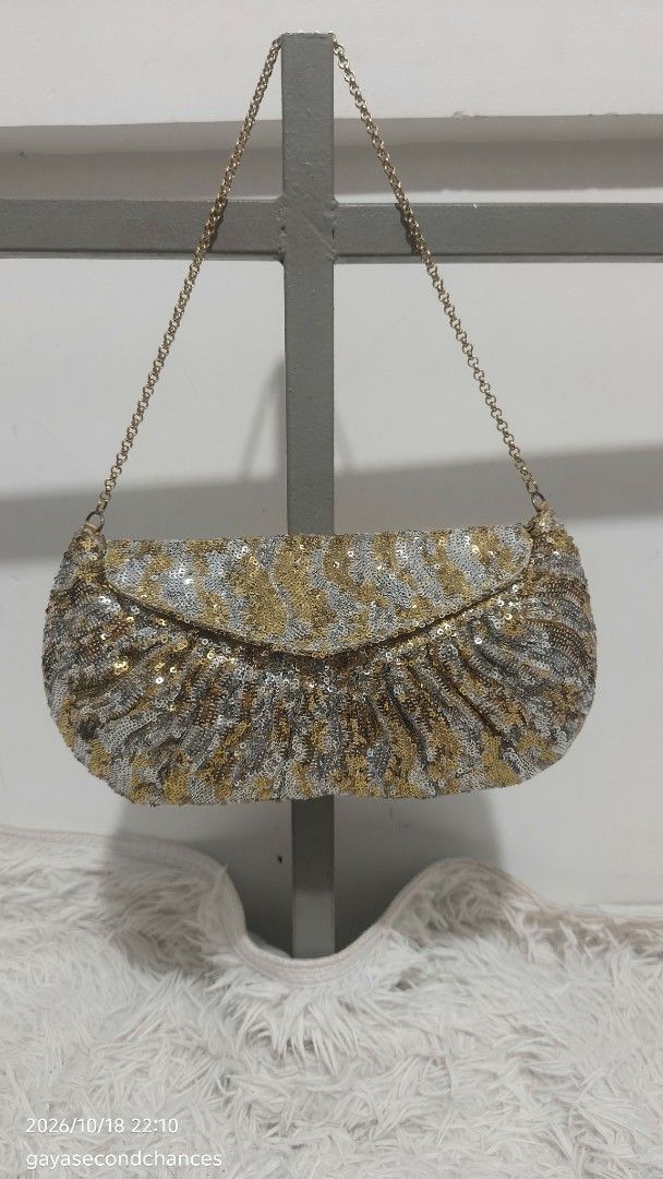 GOLD & SILVER SEQUIN-EMBELLISHED EVENING BAG (Category: Clutches) located in Kalibo. Submitted by secondchances.thriftsh8p (Listing ID 1468889975, Image 1). Description: - Stunning gold and silver sequin design with a chic animal-inspired pattern - Secure flap closure with elegant gathered texture near the base - Includes a detachable/thin gold-tone chain strap for versatile wear - Compact size, ideal for evening events, parties, and night outs -