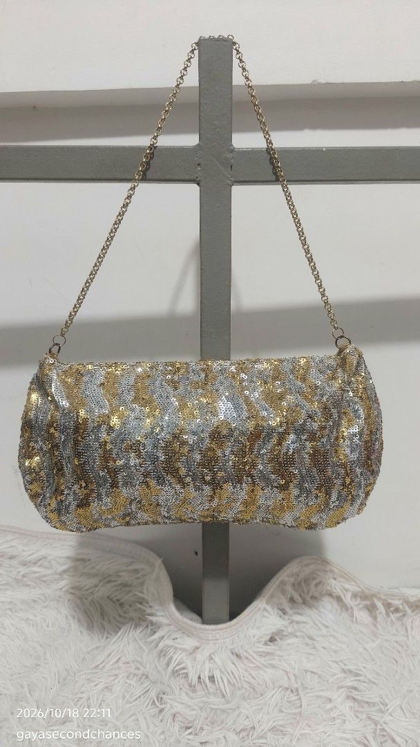 GOLD & SILVER SEQUIN-EMBELLISHED EVENING BAG (Category: Clutches) located in Kalibo. Submitted by secondchances.thriftsh8p (Listing ID 1468889975, Image 2). Description: - Stunning gold and silver sequin design with a chic animal-inspired pattern - Secure flap closure with elegant gathered texture near the base - Includes a detachable/thin gold-tone chain strap for versatile wear - Compact size, ideal for evening events, parties, and night outs -