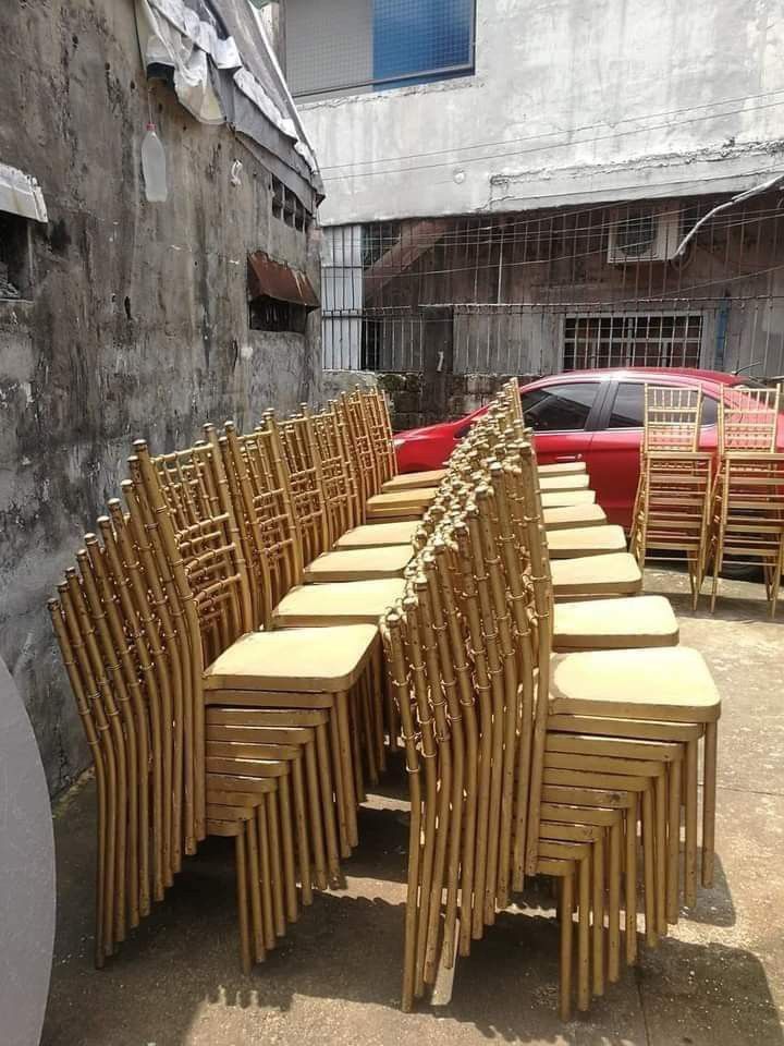 Tifanny chair for rent (Category: Chairs) located in Quezon City. Submitted by bjorn02 (Listing ID 1468853587, Image 3). Description: - Set of gold Chiavari chairs, perfect for weddings, parties, and catering businesses - Classic bamboo-style frame with a durable painted gold finish - Sturdy metal build equipped with comfortable flat cushioned seats - Neatly stackable for easy storage and transport - Shows minor scuffs and wear from regular use, 