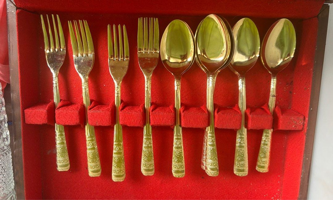 Gold Cutlery Set with Ornate Handles (Category: Dinnerware & Cutlery) located in Quezon City. Submitted by ccr26 (Listing ID 1468786979, Image 1). Description: Never used. Bought in the 90s. Comes in wooden box - Classic vintage style gold-tone flatware set - Features ornate floral engravings along the handles - Includes 4 spoons and 4 forks - Neatly arranged in a red felt-lined storage box - Perfect for special dinners, holiday gatherings, or el