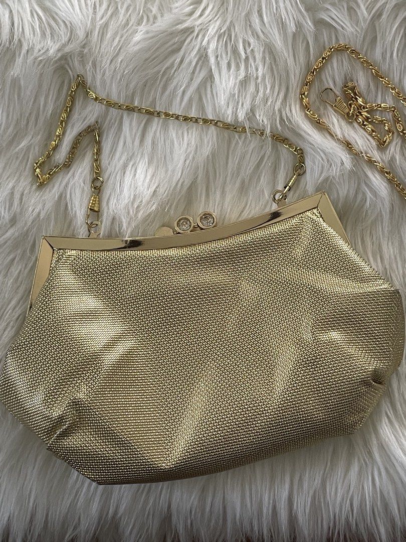 Gold evening clutch bag with chain strap (Category: Clutches) located in San Juan City. Submitted by redrosierose (Listing ID 1468715600, Image 2). Description: - Elegant textured gold clutch with secure gold-tone metal frame - Features a dazzling rhinestone clasp closure on top - Comes with a detachable gold chain strap for shoulder or crossbody wear - Spacious main compartment lined with sleek black fabric - Ideal accessory for weddings, partie