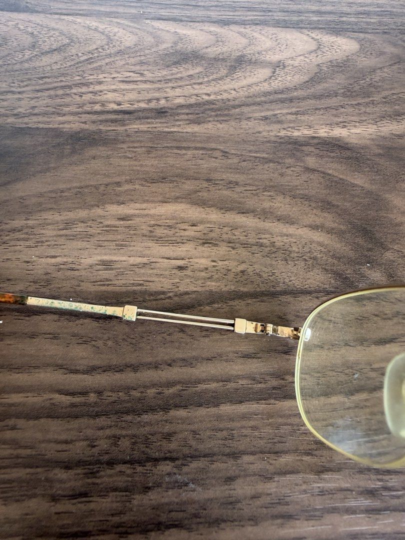 Gold Frame Eyeglasses with Case and Cloth (Category: Sunglasses & Eyewear) located in Digos. Submitted by old_soul. (Listing ID 1468726273, Image 3). Description: - Style: Gold wire frame with rectangular yellow-tinted lenses and tortoiseshell temple tips - Included: Original blue hard case (interior reads "Enjoy Eye Fashion By Changing Your Glasses"), beige suede lining, and branded cleaning cloth - Condition Notes: Oxidation spots on temples, y