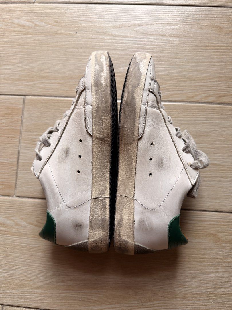 Golden Goose Super-Star Sneakers (Category: Sneakers) located in Cavite. Submitted by newnprelovedbya (Listing ID 1468744737, Image 2). Description: - Brand: Golden Goose - Model: Super-Star Sneakers - Color: White leather with ice suede star and green heel tab - Size: 35 - Features: Metal lettering on the side, comfortable low-top design - Inclusion: Original box included with Passport - Price negotiable.