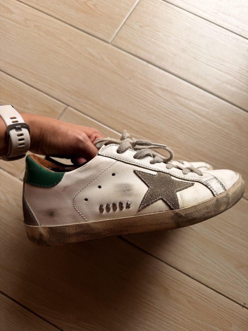 Golden Goose Super-Star Sneakers (Category: Sneakers) located in Cavite. Submitted by newnprelovedbya (Listing ID 1468744737, Image 3). Description: - Brand: Golden Goose - Model: Super-Star Sneakers - Color: White leather with ice suede star and green heel tab - Size: 35 - Features: Metal lettering on the side, comfortable low-top design - Inclusion: Original box included with Passport - Price negotiable.