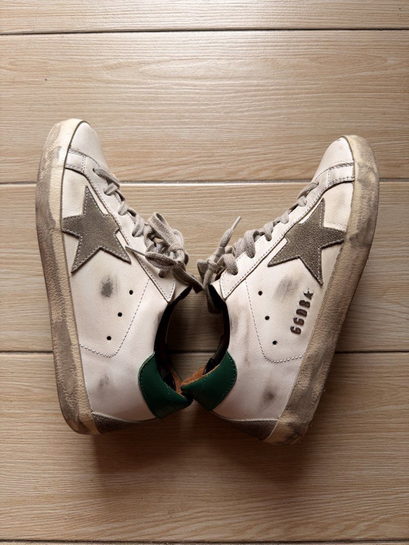 Golden Goose Super-Star Sneakers (Category: Sneakers) located in Cavite. Submitted by newnprelovedbya (Listing ID 1468744737, Image 1). Description: - Brand: Golden Goose - Model: Super-Star Sneakers - Color: White leather with ice suede star and green heel tab - Size: 35 - Features: Metal lettering on the side, comfortable low-top design - Inclusion: Original box included with Passport - Price negotiable.