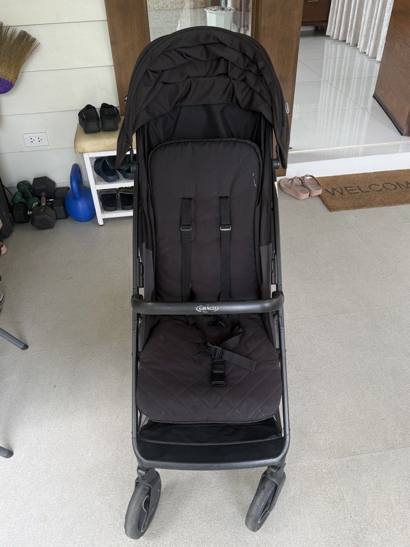 Graco Black Baby Stroller (Category: Strollers) located in Cavite. Submitted by heyitsmeberna (Listing ID 1468756830, Image 1). Description: - Color: Black - Brand: Graco - Large canopy hood for sun protection - Quilted padded seat insert for extra comfort - Built-in underseat storage basket for bags and toys - Lightweight frame that folds easily for travel and storage - Condition: Normal signs of use on the fabric.