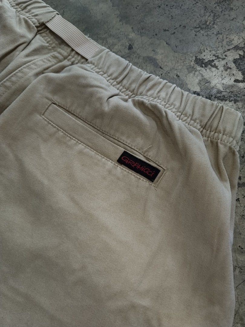 Gramicci Khaki Loose Taper Pants (Category: Trousers) located in Pasig City. Submitted by loveforlux_2025 (Listing ID 1468789682, Image 3). Description: - Brand: Gramicci - Style: Climbing Pants / Outdoor Trousers - Color: Khaki - Size: XL - Material: 98% Cotton, 2% Polyurethane (slight stretch) - Features: Signature integrated belt and buckle, elastic waistband, two front patch pockets, and rear welt pocket with branded label - Origin: Made in C
