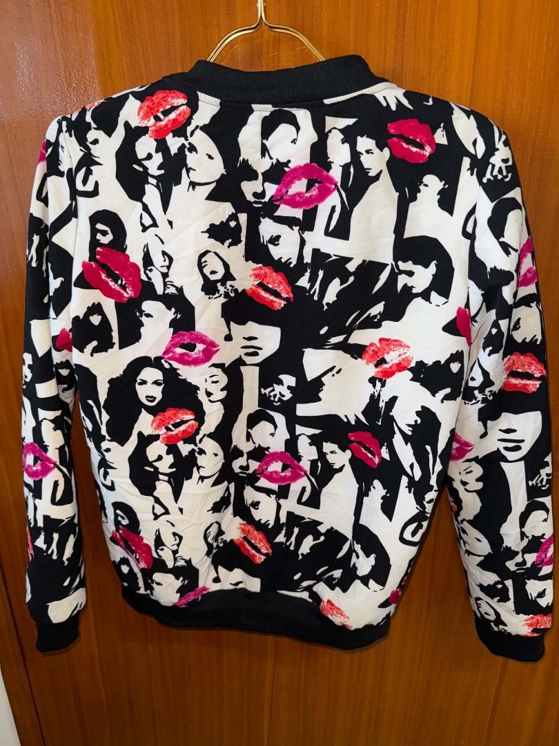 Graphic Print Zip-Up Bomber Jacket Women's Medium (Category: Coats, Jackets and Outerwear) located in Caloocan City. Submitted by mylove326 (Listing ID 1468803868, Image 3). Description: - Eye-catching black and white jacket with bold red lip and woman face graphics - Zip-up front closure for easy wear - Comfortable ribbed collar, cuffs, and hem - Lightweight material, perfect as an outer layer for everyday outfits - Refer to pictures for detaile