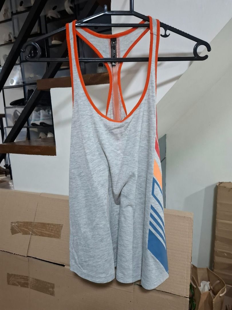 Gray and Orange Racerback Workout Tank (Category: Activewear) located in Pasig City. Submitted by dripcounty (Listing ID 1468837799, Image 1). Description: Gray and Orange Racerback Workout Tank ₱150 Size: Unconfirmed — please confirm in chat Condition: Preloved; please check actual photos Gray marl racerback workout tank with orange trim and colorful side graphics. Brand unconfirmed. Actual item shown in photos. Delivery fee shouldered by buyer 