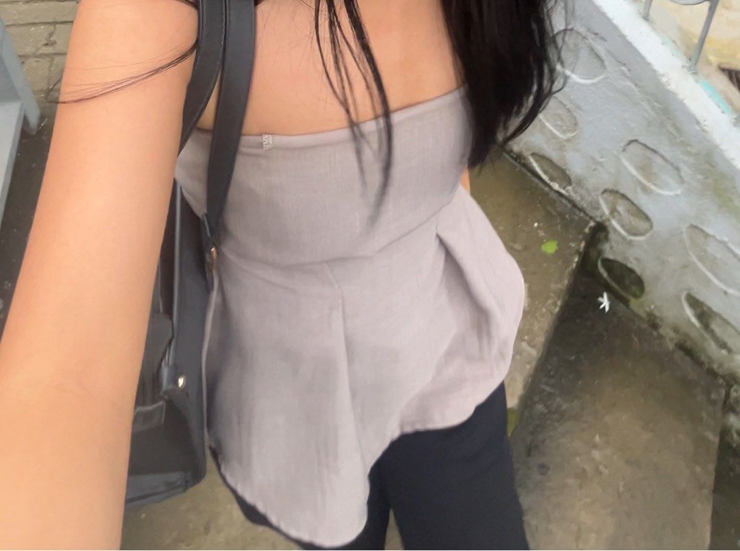 Gray Strapless Pleated Peplum Tube Top (Category: Sleeveless) located in Manila. Submitted by julieeeewwwww (Listing ID 1468844049, Image 3). Description: - Color: Versatile taupe neutral shade - Size: XS-Fitted Med - Design: Strapless with a structured sweetheart bodice and pleated peplum flare at the waist - Fit: Stretchy smocked back panel for a snug and secure fit - Styling: Easily dressed up with trousers or kept casual with jeans - Conditio