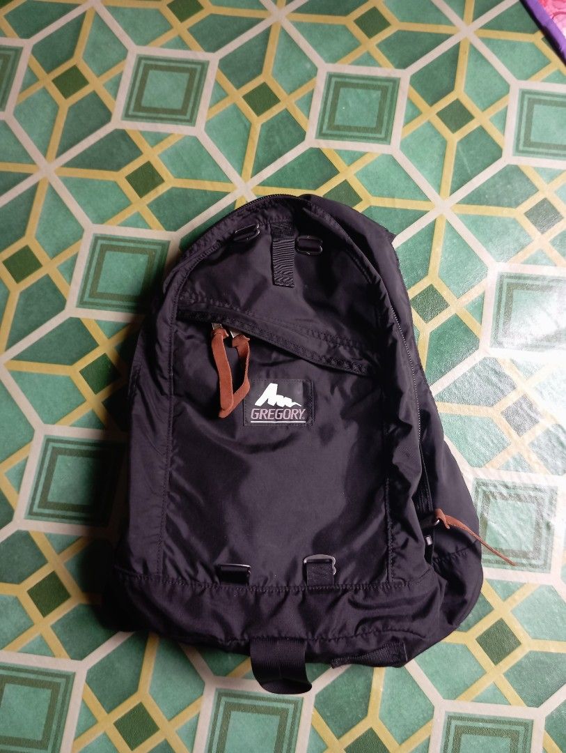 Gregory Black Nylon Backpack with Leather Zipper Pulls (Category: Backpacks) located in Manila. Submitted by jzk25 (Listing ID 1468729808, Image 1). Description: - Brand: Gregory - Color: Classic Black - Material: 100% Nylon (Exterior and Lining) - Origin: Made in Philippines - Hardware: Smooth YKK zippers with stylish brown leather pull tabs - Features: Front zippered pocket, adjustable strap loops on front panel, and clean interior with care ta