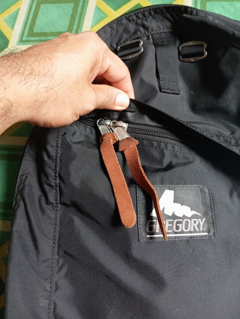 Gregory Black Nylon Backpack with Leather Zipper Pulls (Category: Backpacks) located in Manila. Submitted by jzk25 (Listing ID 1468729808, Image 3). Description: - Brand: Gregory - Color: Classic Black - Material: 100% Nylon (Exterior and Lining) - Origin: Made in Philippines - Hardware: Smooth YKK zippers with stylish brown leather pull tabs - Features: Front zippered pocket, adjustable strap loops on front panel, and clean interior with care ta