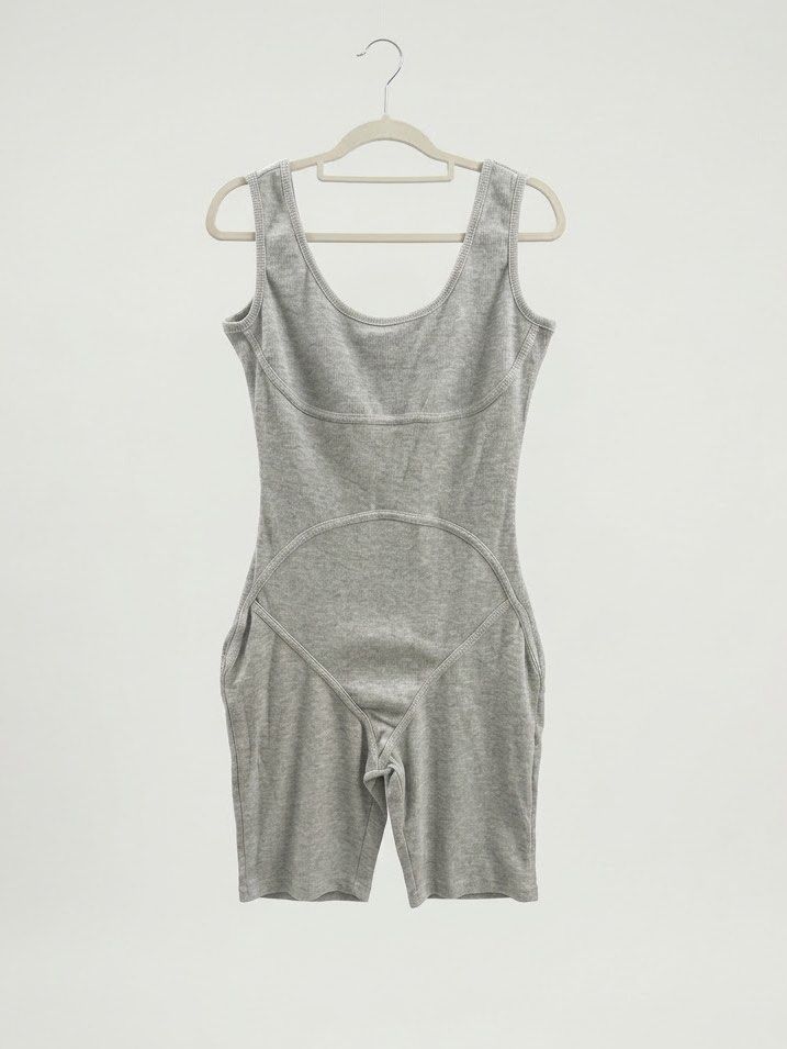 Grey Ribbed Bodysuit Romper Biker Shorts (Category: Rompers) located in Villasis. Submitted by juliaxgamboa (Listing ID 1468808931, Image 1). Description: - Style: Grey ribbed romper with biker shorts - Neckline & Straps: Scoop neck with thick straps - Design: Paneled stitching around chest and lower stomach for a flattering shape - Material: Stretchy cotton knit - Condition: Clean, no stains or holes - Versatility: Perfect for casual days out or