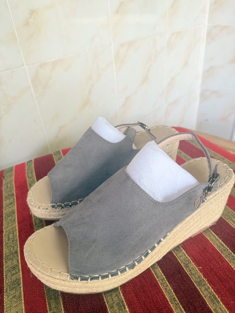 Grey Suede Wedge Espadrille Sandals (Category: Wedges) located in Manila. Submitted by sedpuprincess (Listing ID 1468788015, Image 1). Description: - Style: Grey suede wedge sandals with open toes and slingback ankle straps - Sole: Braided jute platform - Color: Grey upper with beige insoles - Condition: Clean, hardly worn - Care: Stuffed with paper to maintain original shape.