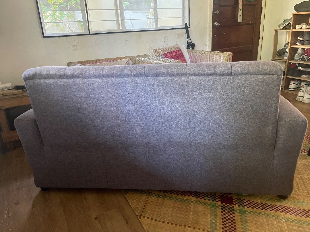 Grey Tufted Fabric Sofa with Armrests (Category: Sofas) located in Cavite. Submitted by diwatashop.online (Listing ID 1468929899, Image 3). Description: - Color: Grey - Material: Clean fabric upholstery - Design: Elegant tufted details on backrest and seat - Comfort: Thick, plush cushions with solid armrests - Capacity: Comfortably seats multiple people - Condition/Build: Sturdy and durable - Ideal for: Living rooms, lounges, and entertainment sp