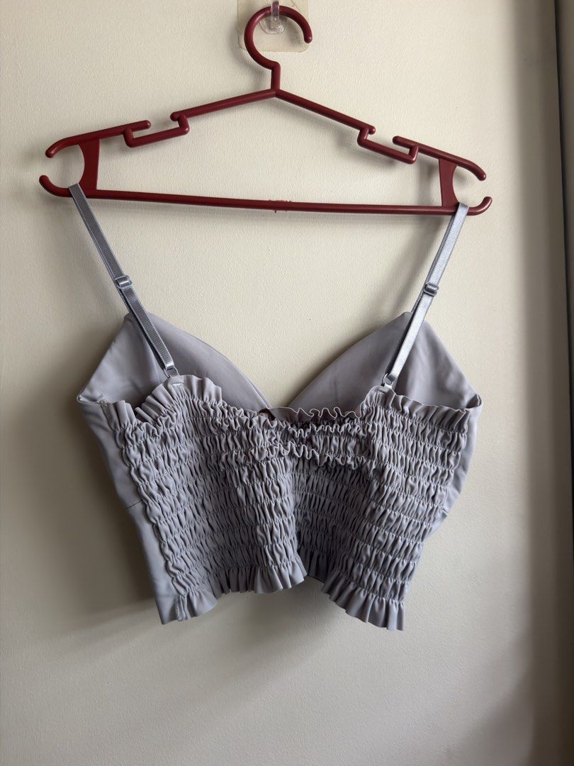 Grey/Light Blue V-neck Padded Cropped Top (Category: Sleeveless) located in Dasmarinas. Submitted by maikee0417 (Listing ID 1468761898, Image 3). Description: - Style: V-neck wrap front cami crop top - Color: Grey / Blue-ish - Features: Built-in padding (no bra needed), adjustable thin straps, and a super stretchy smocked back panel - Condition: Worn a few times, still in great shape RFS: no longer use.