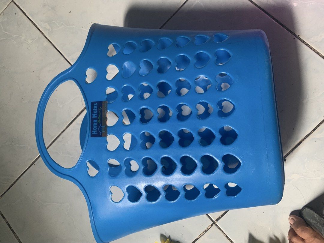 grocery basket set with flower props (Category: Laundry Baskets) located in Valenzuela. Submitted by diane.35 (Listing ID 1468747929, Image 3). Description: - Brand: Home Mates - Color: Blue - Material: Lightweight and durable plastic - Design: Cute cutout heart patterns for ventilation - Features: Sturdy built-in double handles - Condition: Clean, original label sticker still intact - Ideal Use: Laundry, clothes organization, toys, and general h