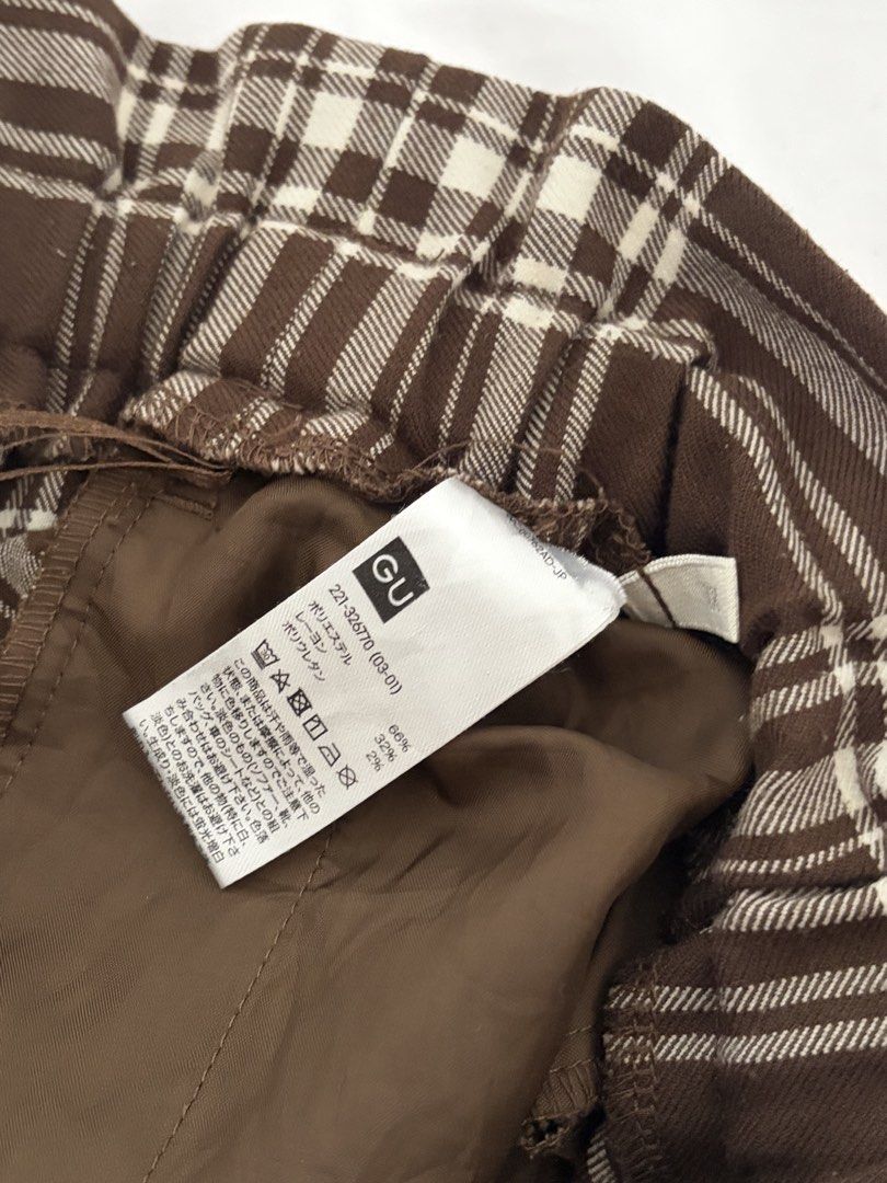 GU Brown Plaid Drawstring Trousers (Category: Trousers) located in Las Pinas. Submitted by thriftedfinds_ (Listing ID 1468829287, Image 3). Description: - Brand/Style: GU brown and white plaid pants - Fit: High-waisted with straight leg cut - Waistband: Elastic with adjustable drawstring tie - Material: 66% polyester, 32% rayon, 2% polyurethane with smooth inner lining - Versatility: Great for casual wear or dressing up.