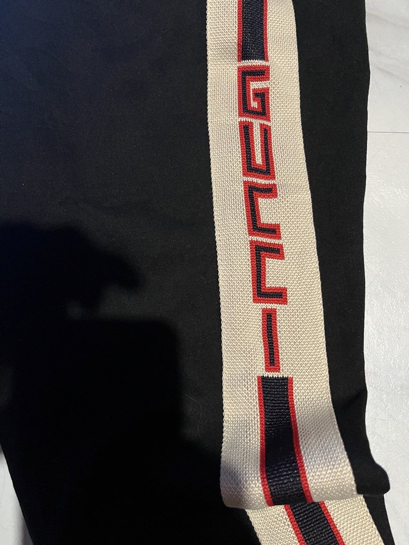 Gucci Black Track Pants with Side Stripe Size L (Category: Joggers) located in Cavite. Submitted by christianzuuu (Listing ID 1468771552, Image 2). Description: - Legit/ Off for items - Brand: Gucci - Item: Black Track Pants - Size: L - Design: Cream, red, and dark blue stripes down the leg with embroidered Gucci lettering - Features: Elastic waistband with drawstring closure, ribbed ankle cuffs, and a back pocket - Measurements: 14.5-inch waist,