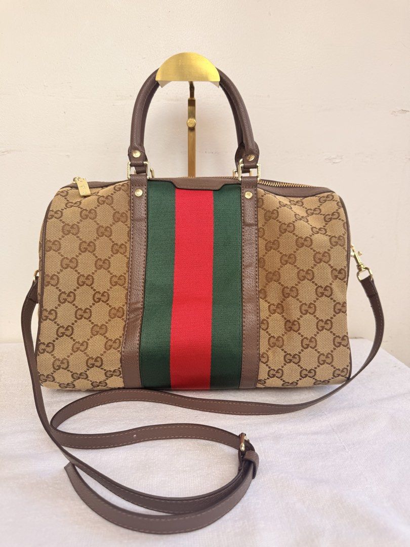 Gucci GG Canvas Web Boston Bag (Category: Luxury Bags & Wallets) located in Consolacion. Submitted by naome1. (Listing ID 1468880320, Image 1). Description: - Authentic qualityGucci boston bag in classic beige and brown monogram canvas - Iconic green and red web stripe accent down the center - Dual leather top handles and a convenient detachable shoulder strap - Secure zip-top closure with engraved gold-tone hardware - Clean leather trim with a s