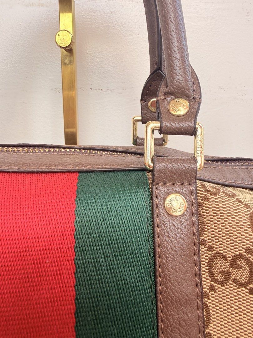 Gucci GG Canvas Web Boston Bag (Category: Luxury Bags & Wallets) located in Consolacion. Submitted by naome1. (Listing ID 1468880320, Image 3). Description: - Authentic qualityGucci boston bag in classic beige and brown monogram canvas - Iconic green and red web stripe accent down the center - Dual leather top handles and a convenient detachable shoulder strap - Secure zip-top closure with engraved gold-tone hardware - Clean leather trim with a s