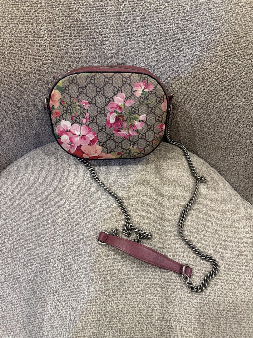 Gucci GG Supreme Blooms Print Camera Bag (Category: Luxury Bags & Wallets) located in Manila. Submitted by savsev (Listing ID 1468778931, Image 1). Description: Gucci GG Supreme canvas camera bag with pink geranium print. Antique silver chain strap with pink leather shoulder pad. Zip closure on top, fabric interior lining with slip pocket and brand tag inside. Compact size, everyday style..