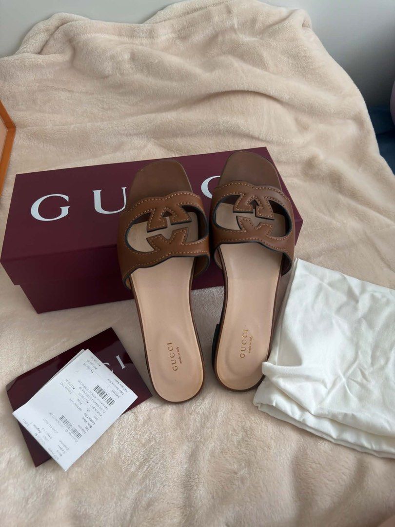 Gucci Interlocking G Brown Leather Slide Sandals (Category: Sneakers & Footwear) located in Manila. Submitted by senpal (Listing ID 1468784813, Image 1). Description: - Brand: Gucci - Style: Brown leather slides with iconic interlocking G cutout - Fit: Flat heel, slip-on design - Insole: Tan leather with stamped Gucci logo - Condition: Excellent, minimal wear visible on soles - Inclusions: Original burgundy packaging box, dust bag, and receipt Or