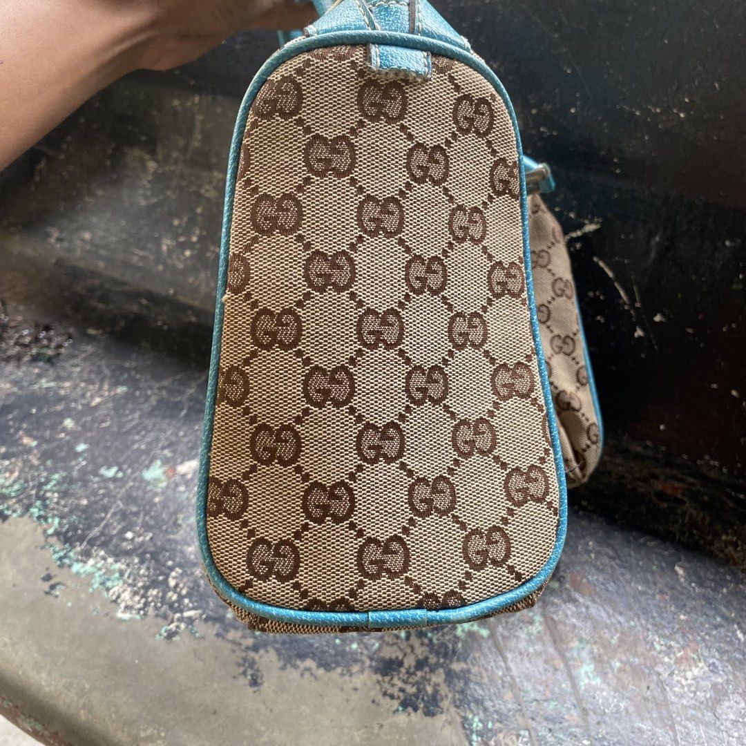 Gucci Monogram Canvas Blue Trim Handbag (Category: Luxury Bags & Wallets) located in Manila. Submitted by 5treetw3ar (Listing ID 1468767136, Image 2). Description: - Brand: Gucci - Material: Classic brown monogram canvas with bright blue leather trim - Hardware: Silver-toned - Closure: Top zipper - Handles: Dual top handles - Structure: Compact silhouette with a flat base (stands upright easily) - Interior: Clean fabric lining - Condition: Excell