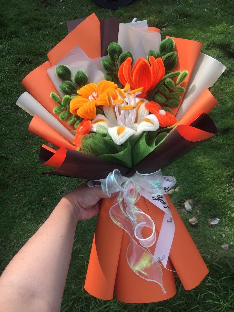 Handmade Pipe Cleaner Flower Bouquet Orange Theme (Category: Flowers & Bouquets) located in Bogo. Submitted by psyche121696 (Listing ID 1468823232, Image 2). Description: - Handmade pipe cleaner flower bouquet in vibrant orange and white - Features handcrafted lilies and green foliage - Beautifully wrapped in layered orange, brown, and translucent paper - Finished with a shiny sheer ribbon and white printed ribbon - Clean, durable, and ready to g