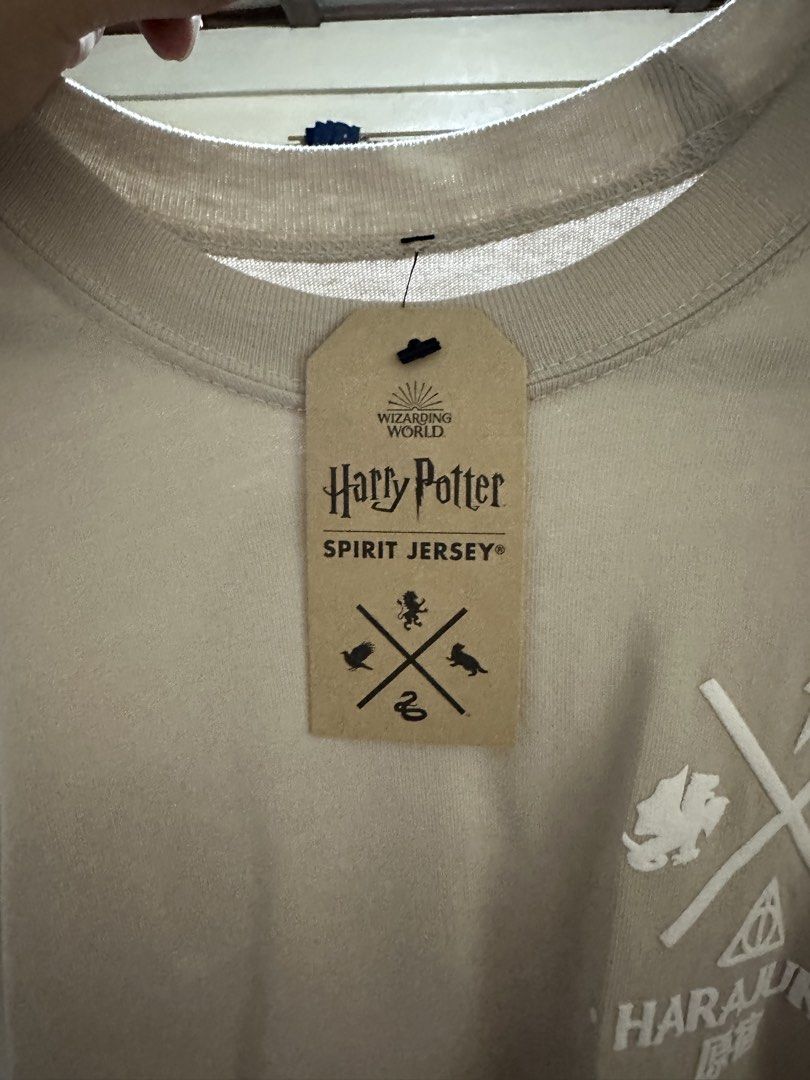 Harry Potter Spirit Jersey (Category: Coats, Jackets and Outerwear) located in Quezon City. Submitted by dragonlily_07251820 (Listing ID 1468806842, Image 3). Description: - Item: Harry Potter Wizarding World Spirit Jersey (bought from Harajuku, Japan) - Condition: Brand new with tag and original packaging card, unused - Color: Light grey with long sleeves and ribbed cuffs - Design: Bold white puff print lettering across the back shoulders - Deta
