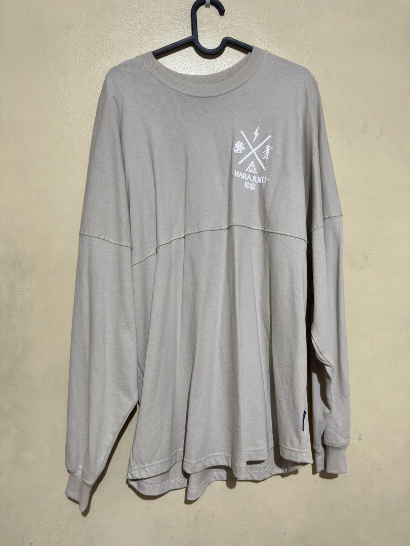 Harry Potter Spirit Jersey (Category: Coats, Jackets and Outerwear) located in Quezon City. Submitted by dragonlily_07251820 (Listing ID 1468806842, Image 1). Description: - Item: Harry Potter Wizarding World Spirit Jersey (bought from Harajuku, Japan) - Condition: Brand new with tag and original packaging card, unused - Color: Light grey with long sleeves and ribbed cuffs - Design: Bold white puff print lettering across the back shoulders - Deta
