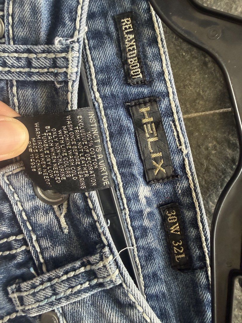 Helix Relaxed Bootcut Jeans 30W 32L (Category: Jeans) located in Burgos, Ilocos Norte. Submitted by copthrift (Listing ID 1468721940, Image 2). Description: Helix relaxed bootcut jeans in a light blue wash. Size 30 waist, 32 length. 100% cotton material. Unique cross design embroidered on both back pockets with distressing details. Made in China. Great Y2K style denim with contrast stitching throughout. Regular button and zip fly closure..