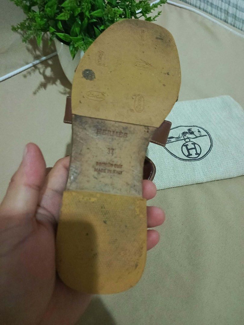 Hermes Brown Leather Sandals Size 37 (Category: Flats & Sandals) located in Cebu City. Submitted by yenetcuba52435 (Listing ID 1468900514, Image 3). Description: - Orig Brand: Hermes - Style: Classic H-strap leather sandals - Size: 37 (EU) - Color: Brown with chic white contrast stitching - Details: Stamped Hermes Paris footbed, leather soles with added rubber heel taps - Origin: Made in Italy - Inclusions: Original dust bag - Condition: Excellen