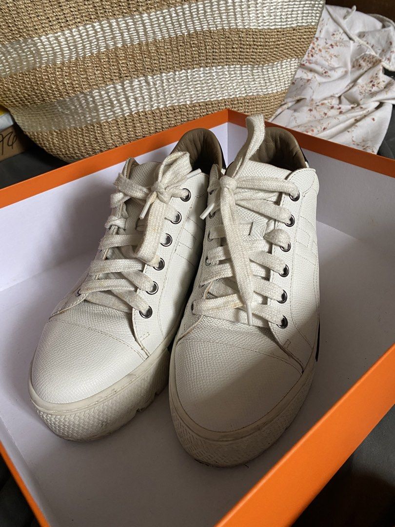 Hermes Voltage White Leather Sneakers (Category: Sneakers) located in Pasay City. Submitted by chesco. (Listing ID 1468745637, Image 2). Description: - Authentic Hermes white leather sneakers - Chic black heel tabs and trendy chunky soles - Features debossed Hermes branding at the back and subtle H motif on the side - Condition: Light signs of wear on midsoles - Inclusions: Original orange box and three dust bags with drawstring closures - Guaran
