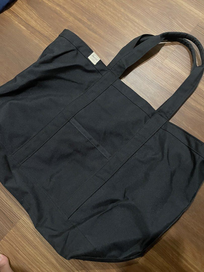 Herschel Black Canvas Tote Bag (Category: Tote Bags) located in Bacolod City. Submitted by jmcercado (Listing ID 1468867049, Image 2). Description: - Brand: Herschel - Color: Classic Black - Material: Sturdy, durable canvas - Design: Features top carry handles, a handy front slip pocket, and the iconic Herschel label on the upper left - Condition: Clean interior, well-maintained - Use: Versatile everyday bag ideal for work, school, or daily commu