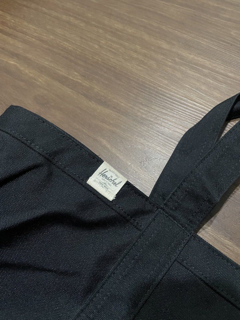 Herschel Black Canvas Tote Bag (Category: Tote Bags) located in Bacolod City. Submitted by jmcercado (Listing ID 1468867049, Image 3). Description: - Brand: Herschel - Color: Classic Black - Material: Sturdy, durable canvas - Design: Features top carry handles, a handy front slip pocket, and the iconic Herschel label on the upper left - Condition: Clean interior, well-maintained - Use: Versatile everyday bag ideal for work, school, or daily commu