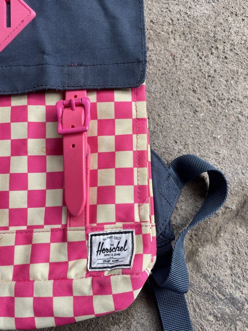 Herschel Supply Co. Pink Checkered Backpack (Category: Backpacks) located in General Santos City (Dadiangas). Submitted by christbluee (Listing ID 1468827607, Image 3). Description: - Brand: Herschel Supply Co. - Design: Pink & cream checkered pattern with dark navy top flap and bright pink buckle straps - Interior: Signature red and white striped fabric lining - Details: Classic diamond lash tab, branded H.S.Co. hardware, and front brand patch -