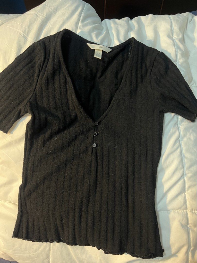 H&M Black Ribbed Button-Down Top (Category: Longsleeves) located in Marikina City. Submitted by yssacee (Listing ID 1468920133, Image 1). Description: - Brand: H&M - Color: Black - Size: XS - Style: Short sleeves, deep V-neckline with 3 functional buttons, fitted silhouette - Material: Lightweight, soft ribbed knit - super elegant but does not fit me anymore - shipping from lower antipolo rizal - pm for more photos.