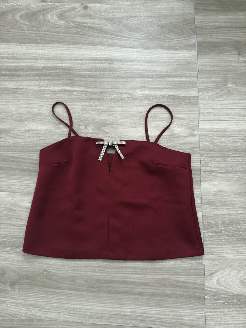 H&M Cami Top (Category: Sleeveless) located in Las Pinas. Submitted by _audi (Listing ID 1468767660, Image 2). Description: - Color: Deep red - Size: Small - Design: Thin straps, keyhole cutout with rhinestone bow - Fit: Relaxed - Condition: Great, worn only once for photos - Perfect for: Date nights or casual outings styled with jeans or a skirt.