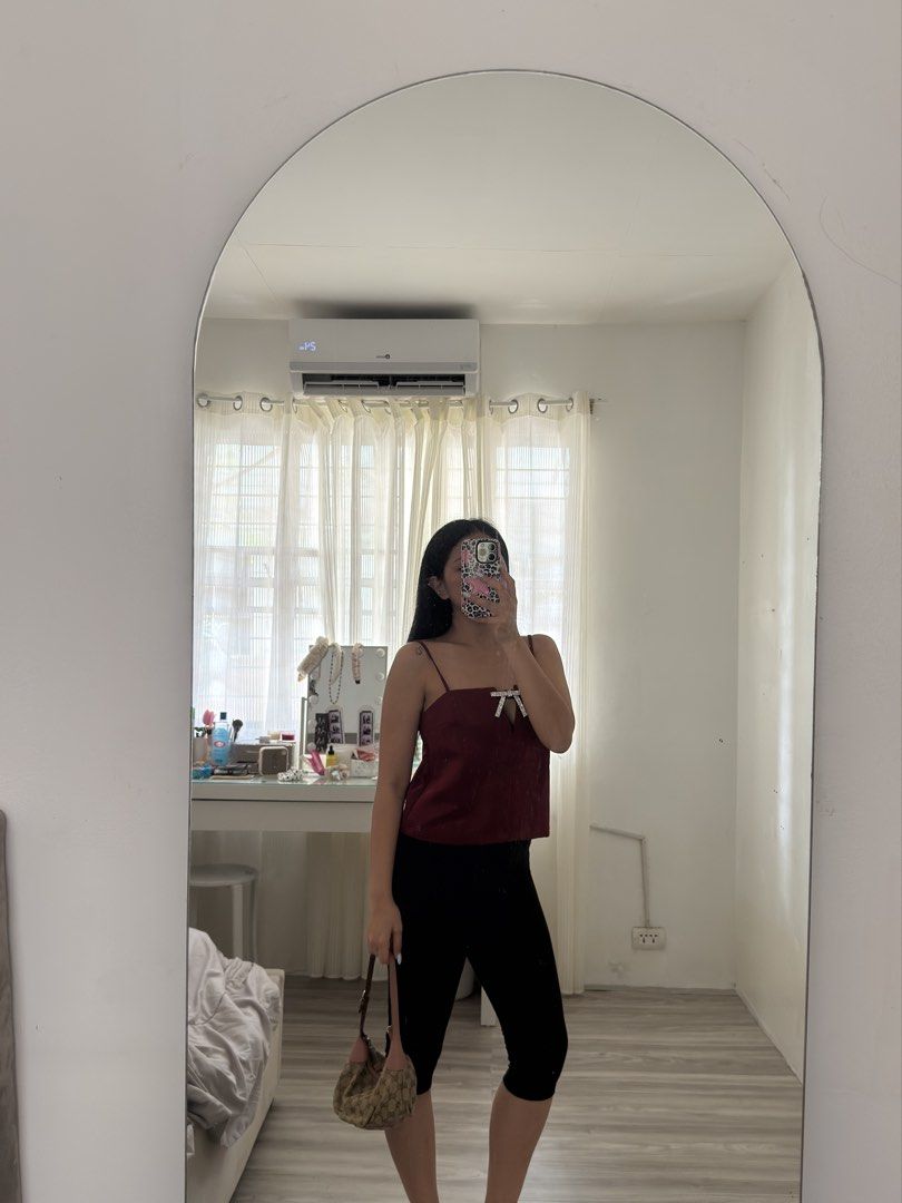 H&M Cami Top (Category: Sleeveless) located in Las Pinas. Submitted by _audi (Listing ID 1468767660, Image 1). Description: - Color: Deep red - Size: Small - Design: Thin straps, keyhole cutout with rhinestone bow - Fit: Relaxed - Condition: Great, worn only once for photos - Perfect for: Date nights or casual outings styled with jeans or a skirt.