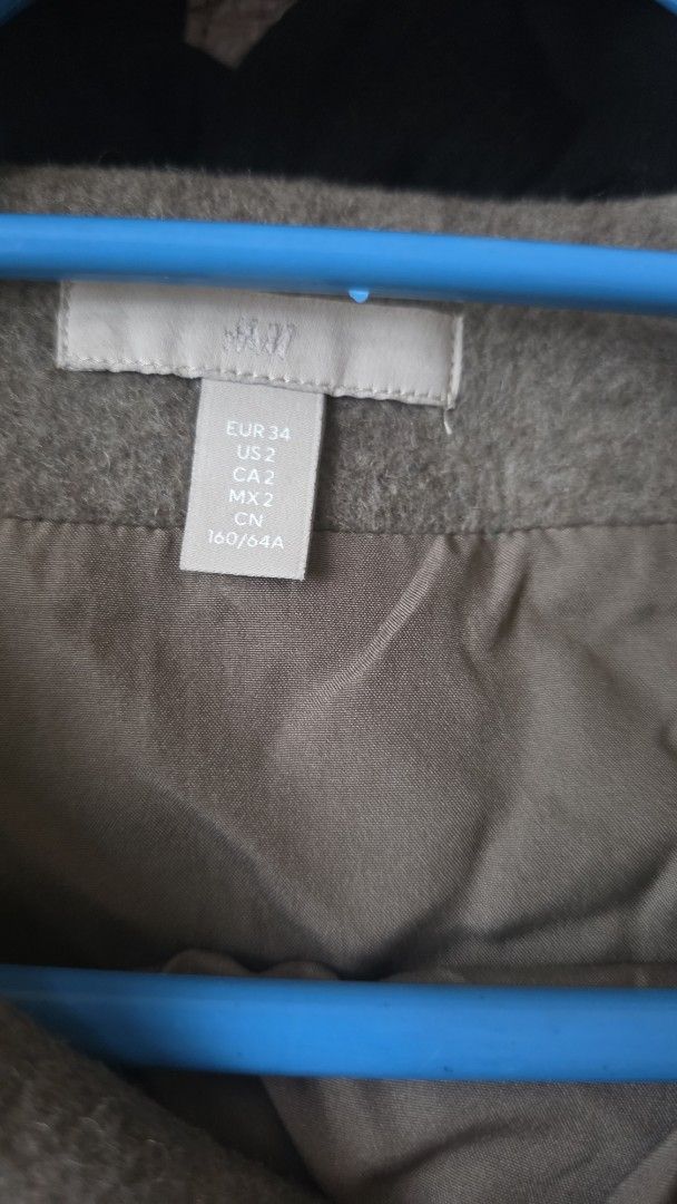 H&M Grey Mini Skirt (Category: Skirts) located in Las Pinas. Submitted by lovedbymariee (Listing ID 1468728402, Image 3). Description: - Brand: H&M - Item: Grey wool-like material mini skirt - Size: EUR 34 / US 2 / CA 2 / MX 2 / CN 160/64A - Details: Wrap-style front with single metallic button closure, fully lined for comfort - Condition: Great pre-loved condition - Style Tip: Versatile neutral piece, perfect for layering during cooler weather.